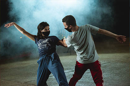 Male and Female interpretive dancers perform in fog.